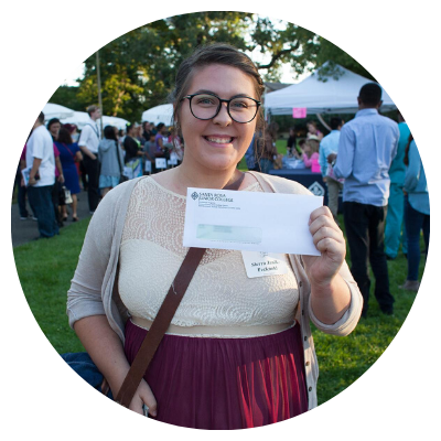 female student holding financial aid check