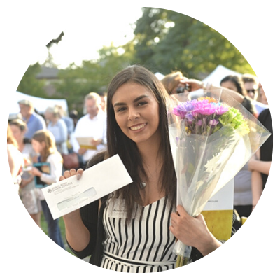 female student holding a financial aid check